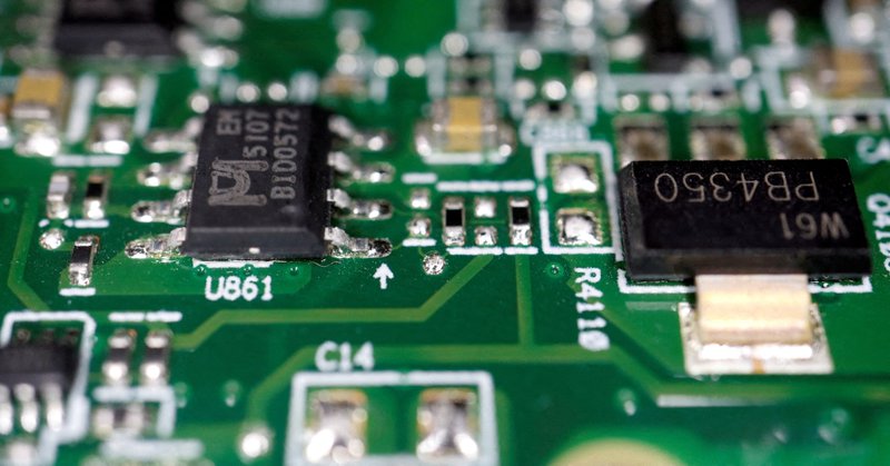 Semiconductor chips are seen on a printed circuit board. REUTERS/Florence Lo/Illustration
