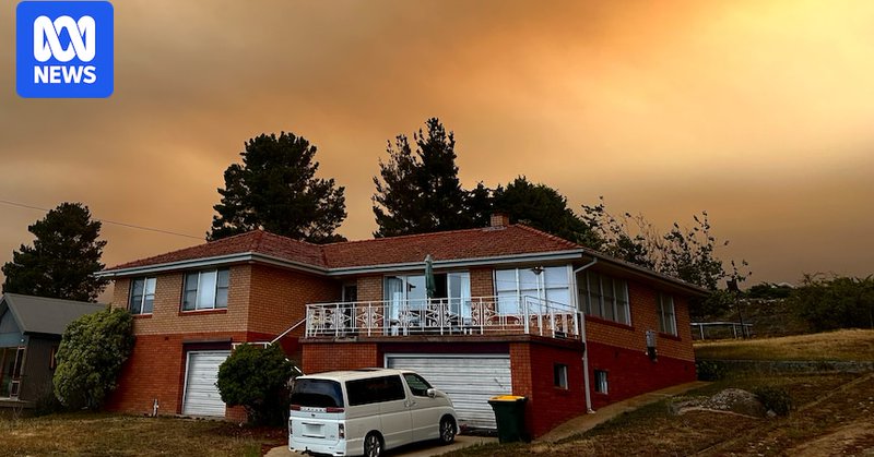 Smoke-filled clouds cover the skyline and hover over a house in Jindabyne in New South Wales.