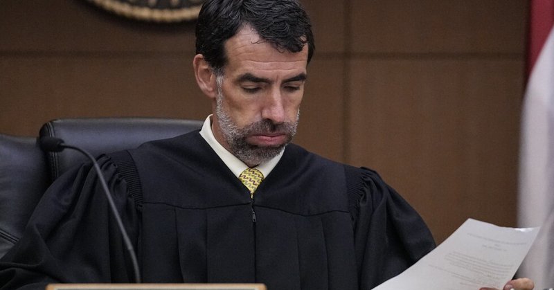 FILE - Fulton County Superior Court Judge Robert McBurney looks through paperwork, Monday, Aug. 14, 2023, in Atlanta. (AP Photo/Brynn Anderson, File)