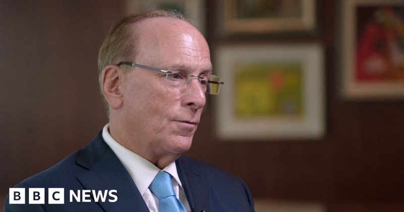 Blackrock CEO Larry Fink being interviewed. He is wearing a dark blue suit, white shirt and light blue tie