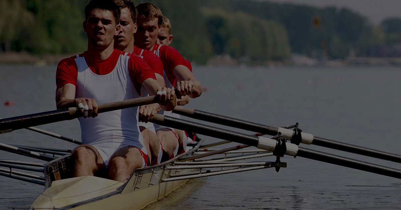 Team rowing in sync on a lake, symbolizing collaboration and alignment with Gravity Software and Microsoft 365