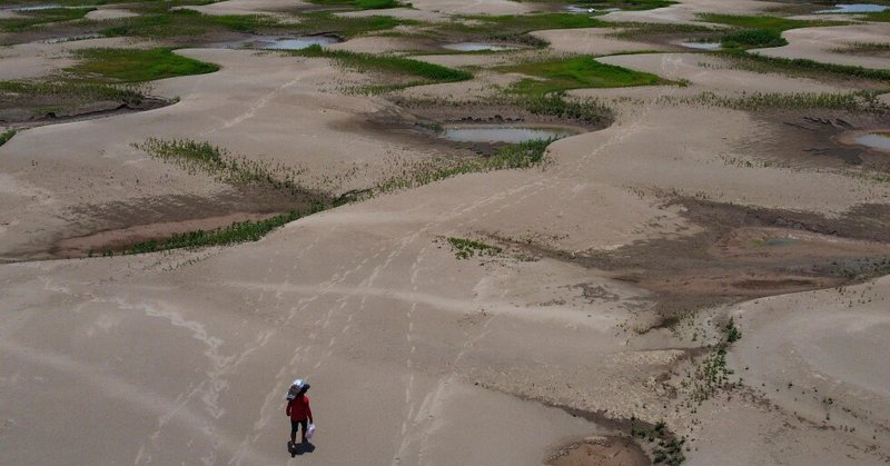 A resident of a riverside community carries food and containers of drinking water after being distributed due to the ongoing drought in Careiro da Varzea, Amazonas state, Brazil, Oct. 24, 2023. (AP Photo /Edmar Barros, File)
