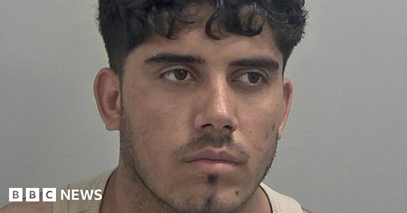 Ahmad Mulakhil wears a light brown vest. He has curly black hair over his forehead and slight black stubble.