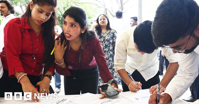 Students filling out forms at a job fair in Delhi June 2025