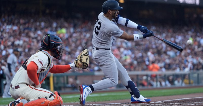 New York Yankees' José Caballero, right, hits an RBI double in front of San Francisco Giants catcher Patrick Bailey, left, during the second inning of a baseball game in San Francisco, Wednesday, March 25, 2026. (AP Photo/Jeff Chiu)