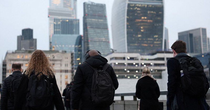 Workers cross London Bridge during the morning rush-hour with skyscrapers of the City of London financial district seen behind, in London, Britain, December 16, 2025. REUTERS/Toby Melville/File Photo