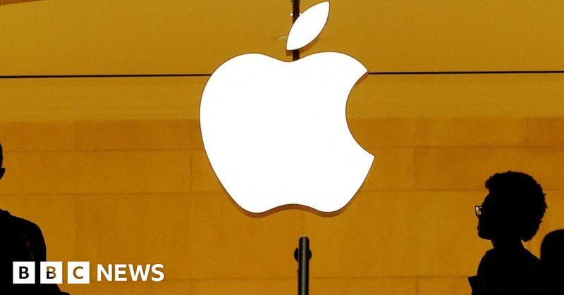 Apple logo glows in white on yellow background with shadows of people walking past