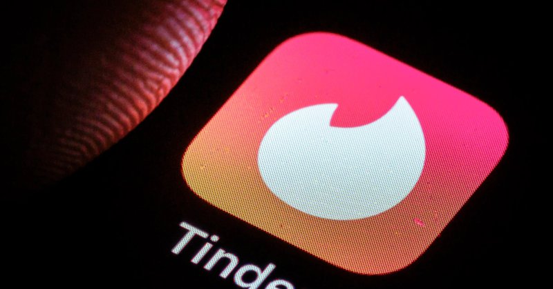 Illustration of the Tinder app logo and text on a smartphone screen.