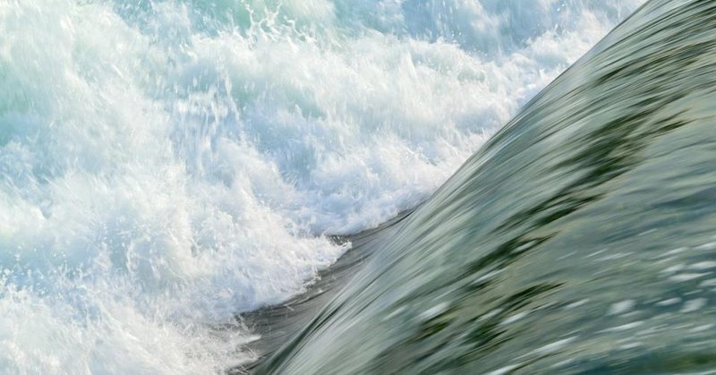 A sheet of water cascades to break into white foam