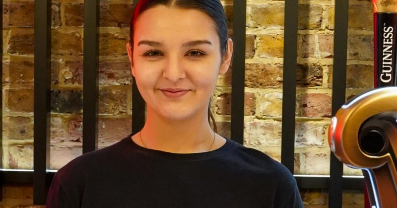 An image collage containing 1 images, Image 1 shows Laila McDougall behind a bar with Guinness harp displays and taps