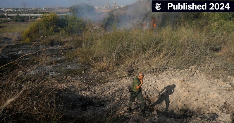 A police officer inspecting the area around a fire after the Israeli military said it tried to intercept a missile launched from Yemen on Sunday.