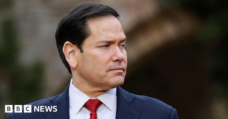 Headshot of Rubio who looks off to the side. There's a blurred background