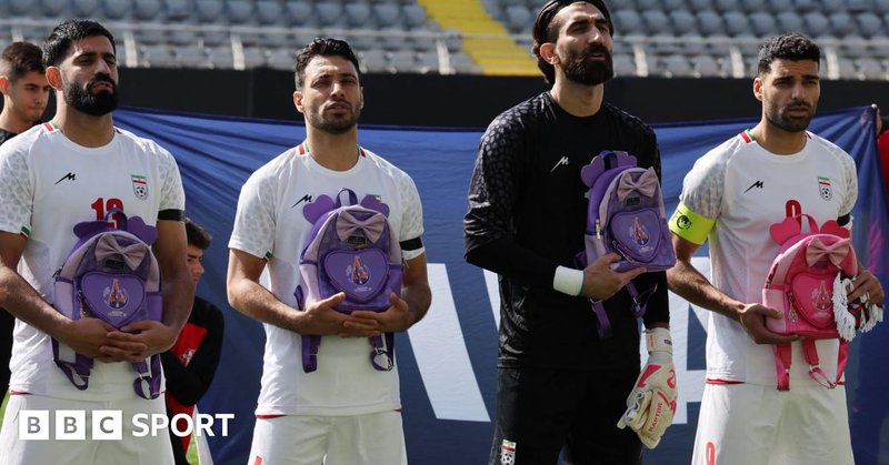 Iran's Hossein Kanaani, Shoja Khalilzadeh, Alireza Beiranvand and Mehdi Taremi hold school bags in memory of the victims of the girls school bombing in Minab, Iran