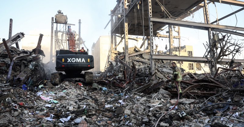 A firefighter stands on the rubble of residential buildings near Niloufar square in Tehran during the ongoing joint U.S.-Israeli military campaign on Iran on March 2, 2026.