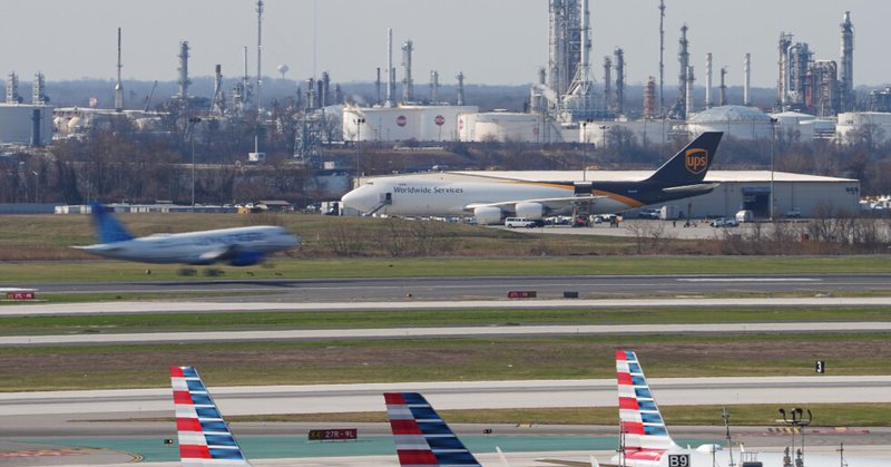 An airplane lands in view of a refinery at Philadelphia International Airport in Philadelphia, Thursday, March 26, 2026. (AP Photo/Matt Rourke)
