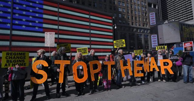 Demonstrators hold a protest against the war on Iran next to Recruting Station in Times Square, New York City, United States, on Sunday, March 22, 2026. [Selçuk Acar - Anadolu Agency]