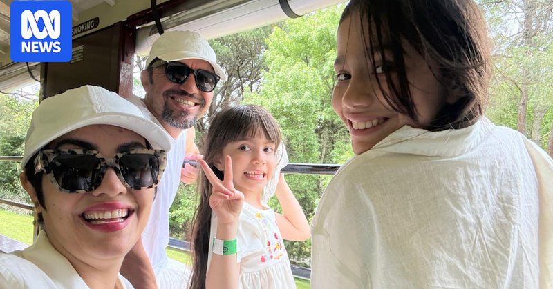 A family outdoors smiling