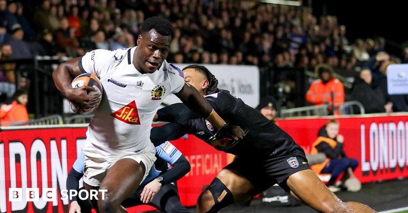Exeter winger Paul Brown-Bampoe (left) with the ball in his right hand goes through an attempted tackle from Elliot Obatoyinbo
