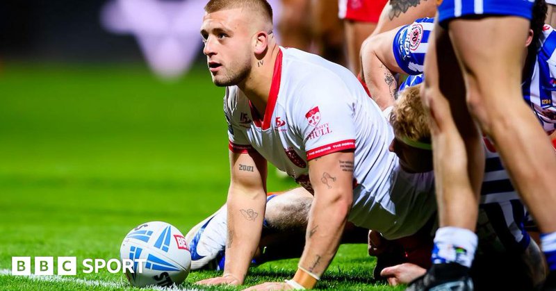 Hull KR half-back Mikey Lewis scoring a try against St Helens and looking up towards the crowd in celebration with the ball still on the whitewash.