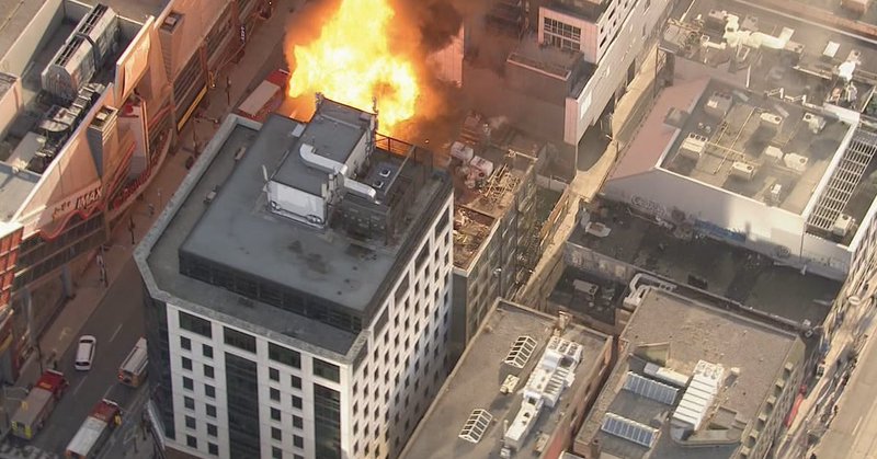 A large fire is seen on the roof of a downtown Toronto building on Friday, March 27, 2026. (Chopper 24)