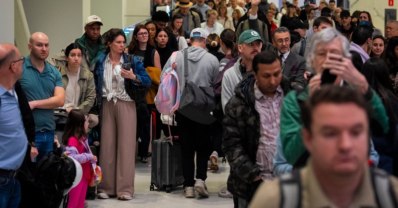 People waiting in line to go through security check at LaGuardia Airport in Queens, New York, on Friday.