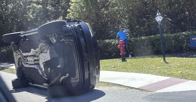 Tiger Woods by his overturned vehicle in Jupiter Island, Florida. Pic: AP