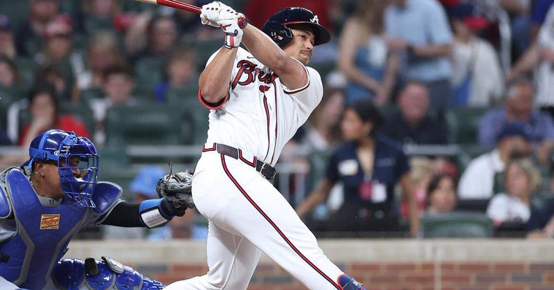 Braves designated hitter Drake Baldwin belts a solo home run off Kansas City Royals starting pitcher Cole Ragans (not pictured) during the third inning of both teams’ MLB season opener at Truist Park in Atlanta on Friday, March 27, 2026. At left, catching, is KC’s Salvador Perez.
