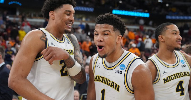 Michigan, from left to right, Yaxel Lendeborg, Trey McKenney and Nimari Burnett celebrate after defeating Alabama in the Sweet 16 of the NCAA college basketball tournament, Friday, March 27, 2026, in Chicago. (AP Photo/Erin Hooley)