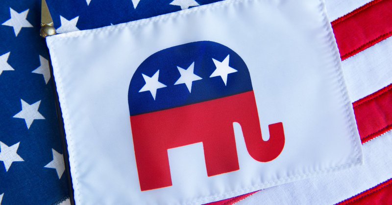 Republican elephant symbol on a flag on top of the American flag – stock photo (no date provided)