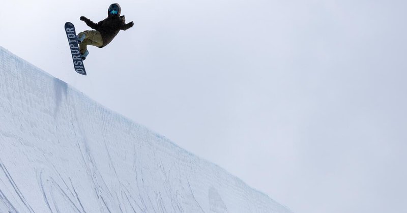 A snowboarder flies above the lip on the Olympic-sized, 22-foot-tall half pipe at Mammoth Mountain on March 14, 2024.