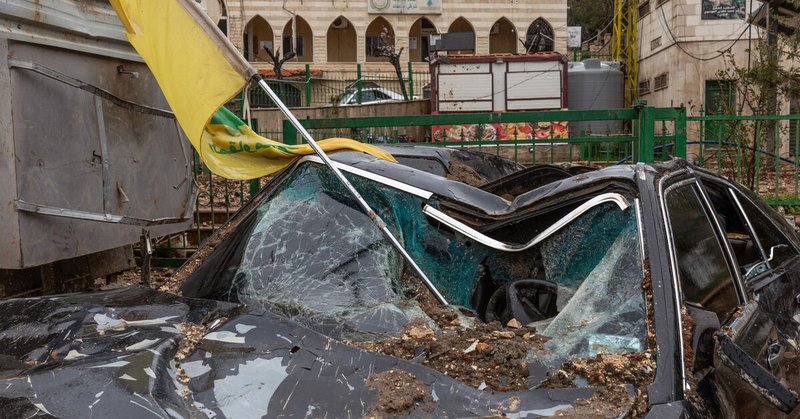 A Hezbollah flag is seen in a destroyed car after an Israeli airstrike in Nabi Chit, Lebanon, on March 26, 2026.