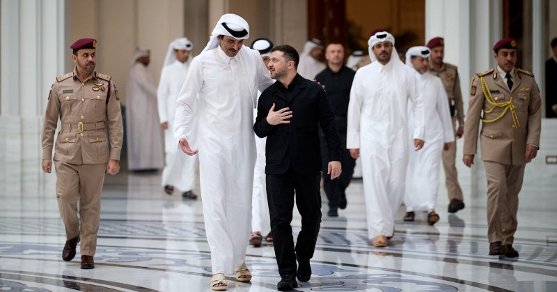 In a photo released by the Ukrainian Presidential Press Service, President Volodymyr Zelensky, in black, and Emir Sheikh Tamim bin Hamad al-Thani of Qatar, center left, walk together during their meeting in Doha, Qatar, on Saturday.