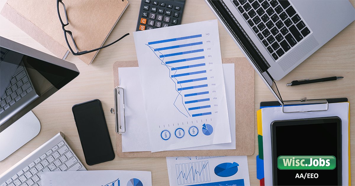Image:data graphs surrounded by office supplies; Wisc.Jobs AA/EEO