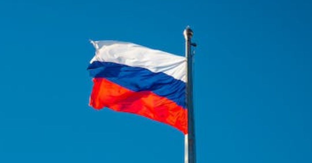 Photograph of a Russia Flag Under a Blue Sky