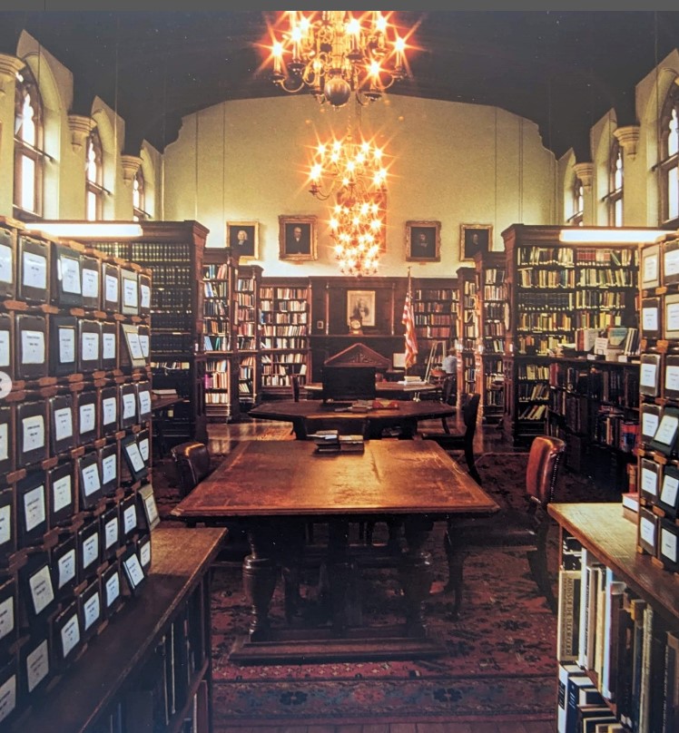 A view looking down a library. On each side are card catalogue boxes.
