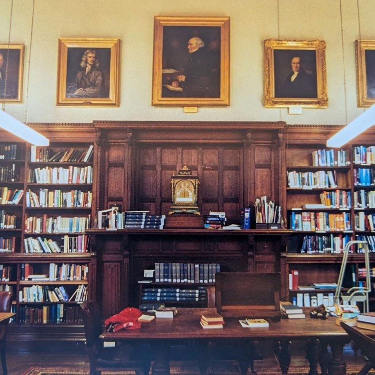 Books surround a fireplace.