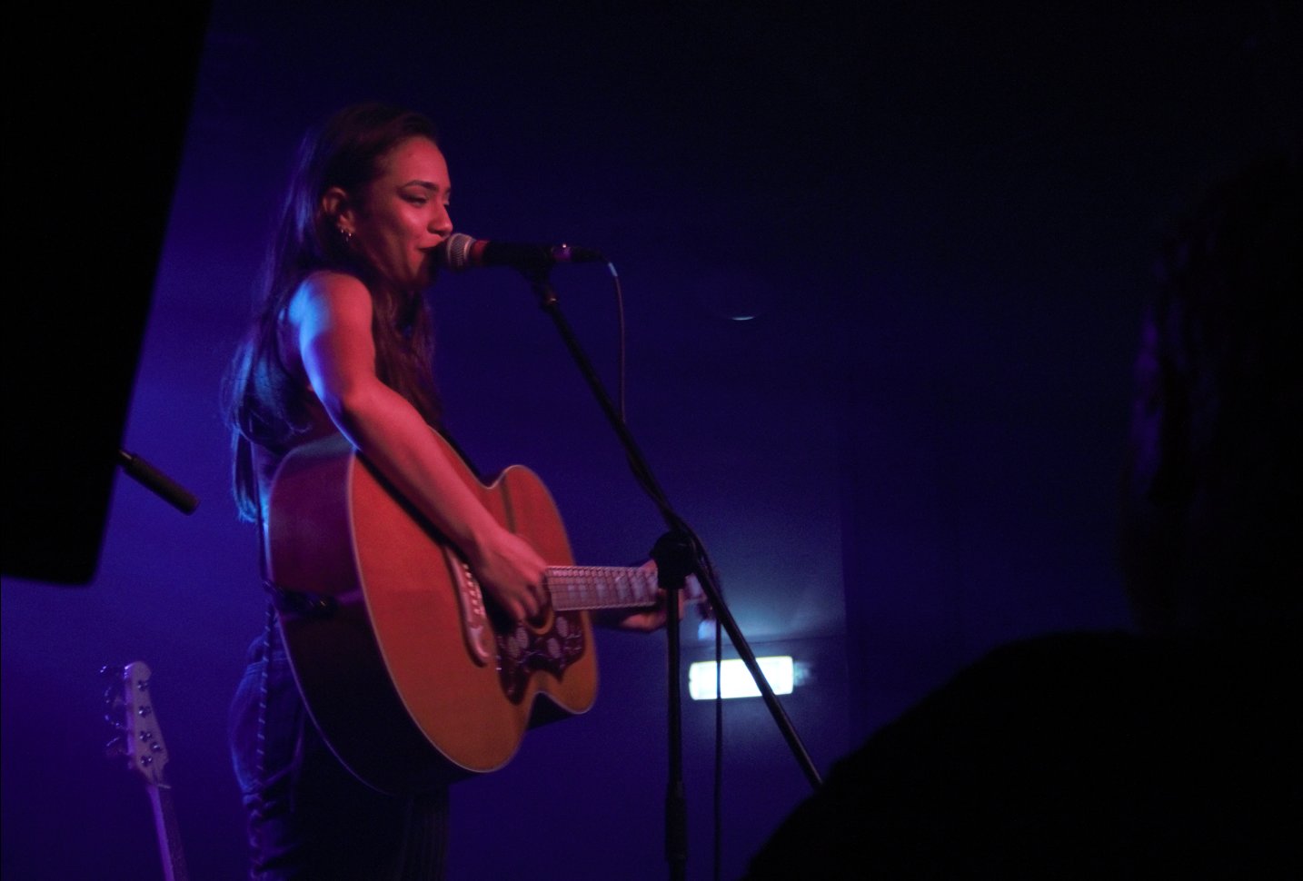 Ruby J singing and playing guitar live in Birmingham