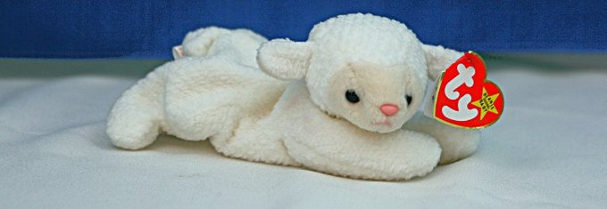 a picture of a small fleecy sheep plushie
