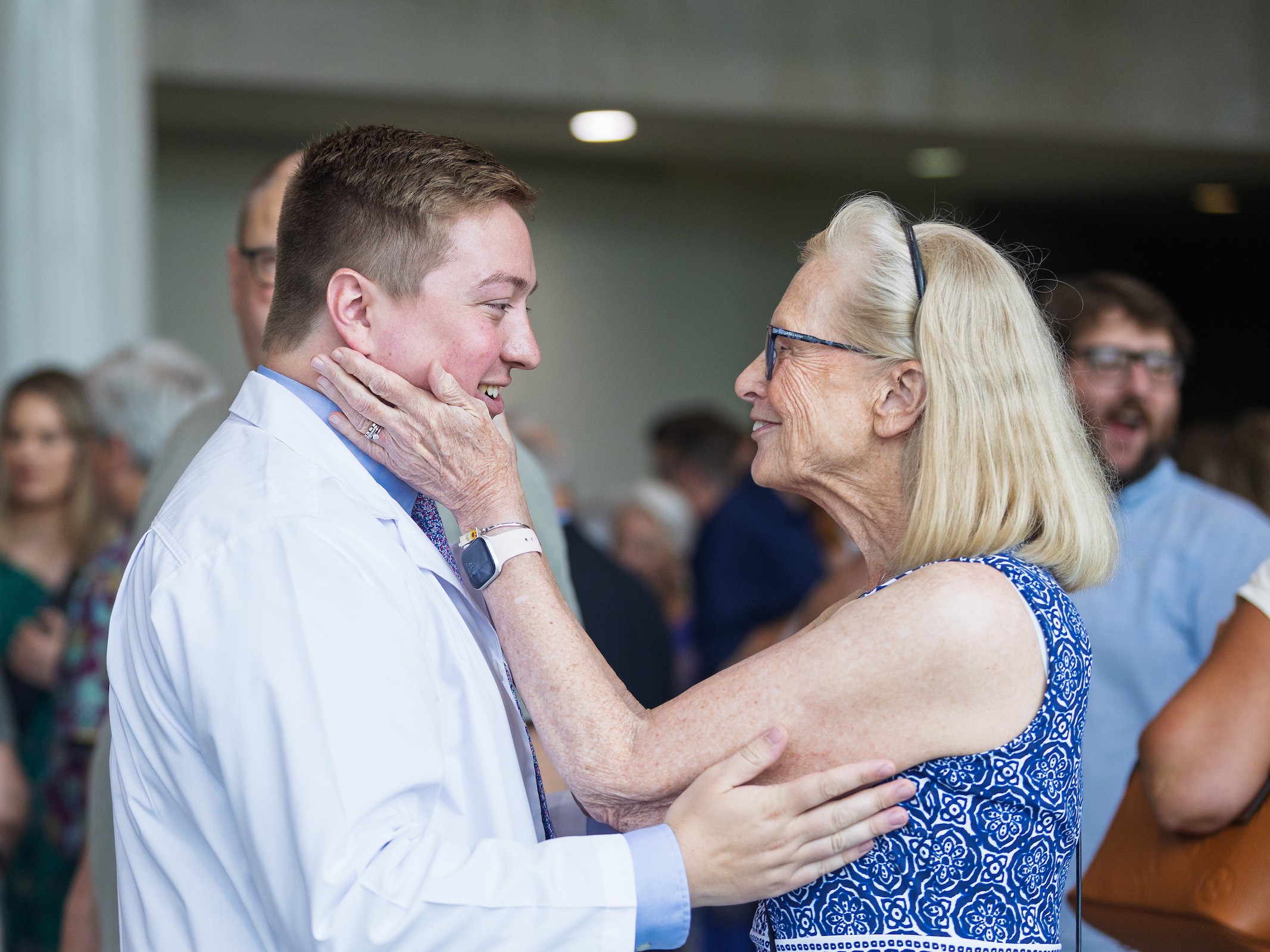 A Valparaiso University master of science in physician assistant studies student smiles with a parent during their white coat ceremony.