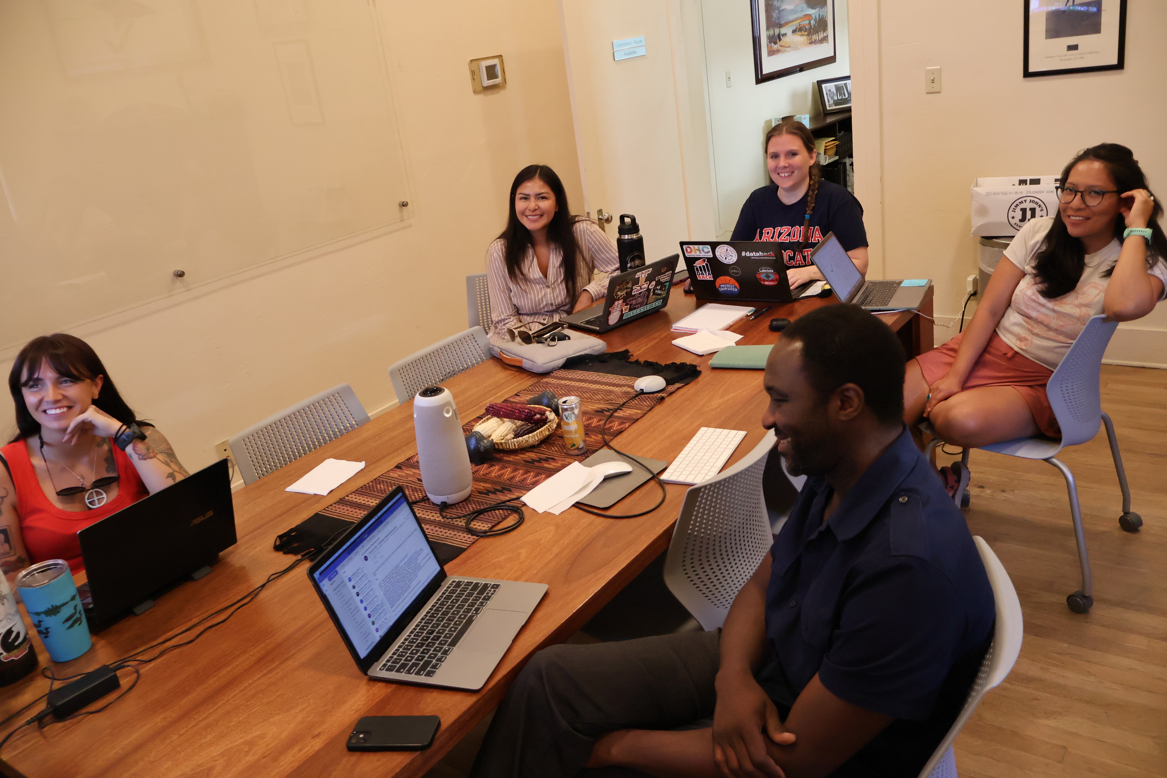 Collab members gather around a conference table in the Udall Center Conference Room during the first day of their three-day gathering.