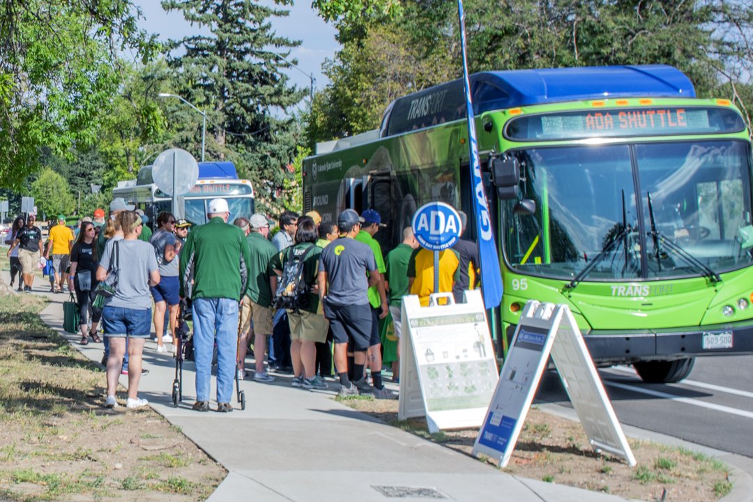 People waiting in line to board a bus.