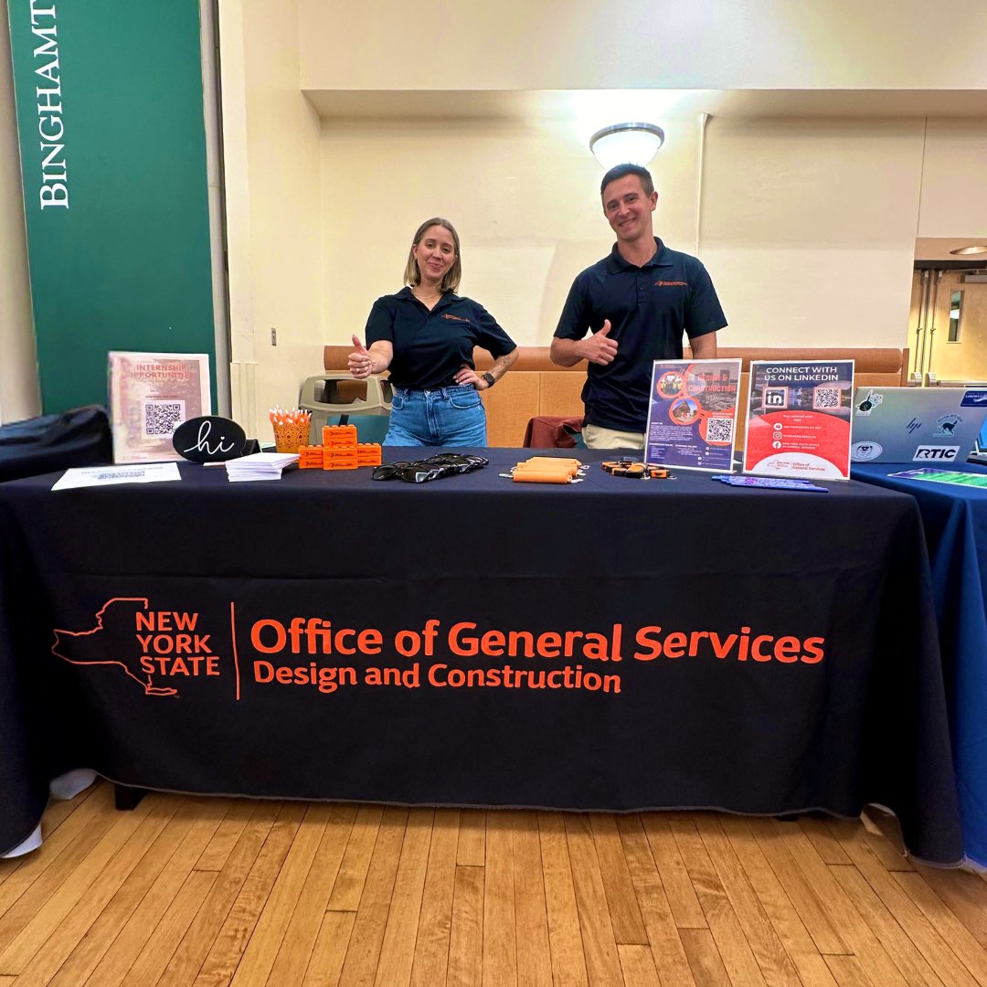 Two New York State Office of General Services team members give a thumbs up at a Career Fair.