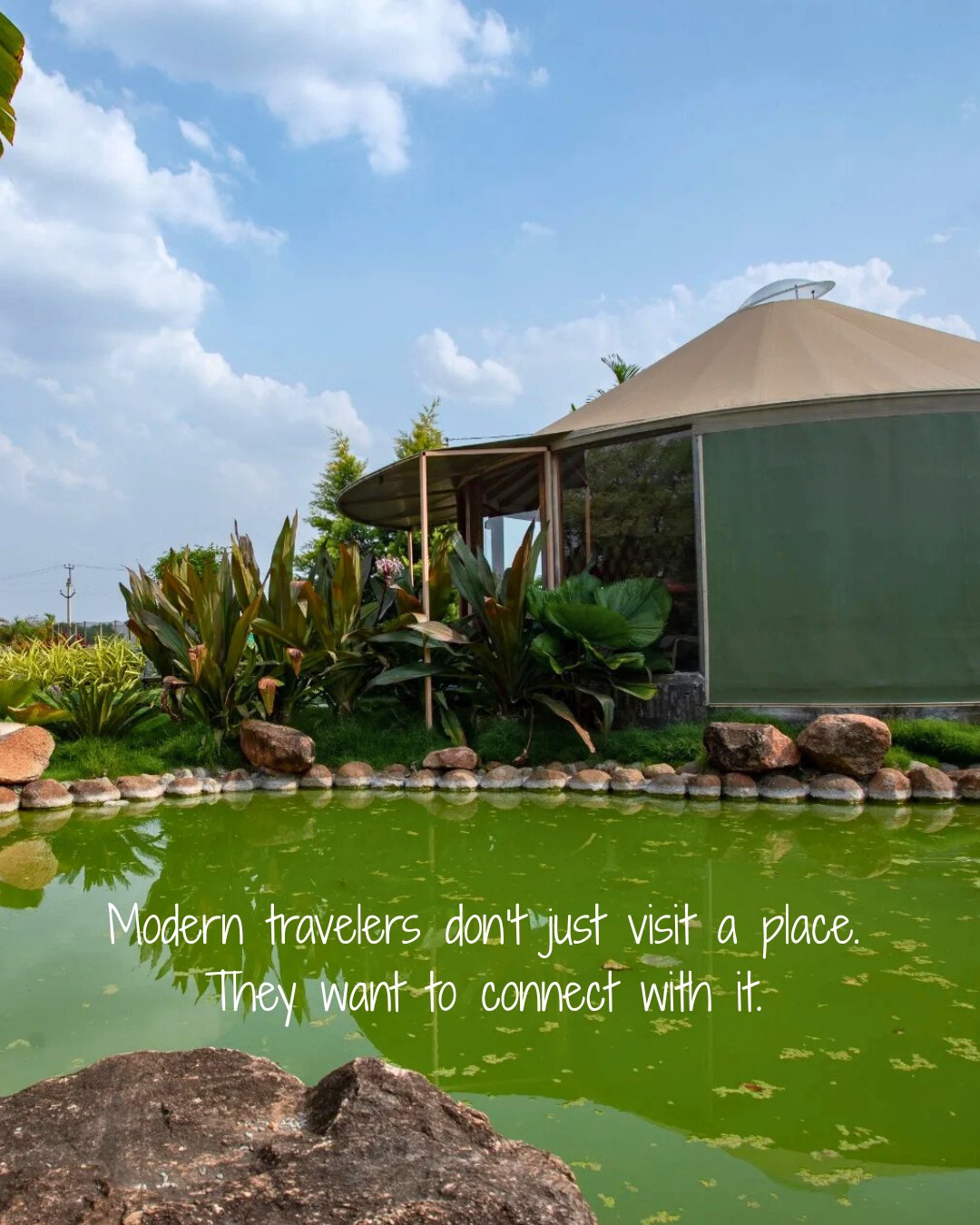 A modern yurt beside a green pond surrounded by lush plants under a partly cloudy sky.