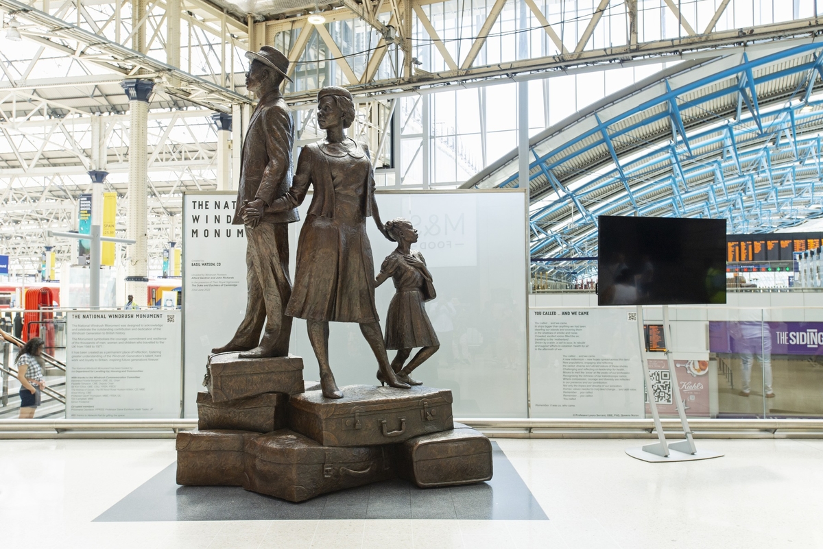 The sculpture portrays three figures – a man, woman and child – dressed in their 'Sunday best' climbing a mountain of suitcases, hand in hand.