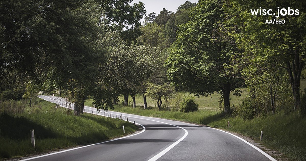Image: winding highway lined with grass and trees; Wisc.Jobs AA/EEO