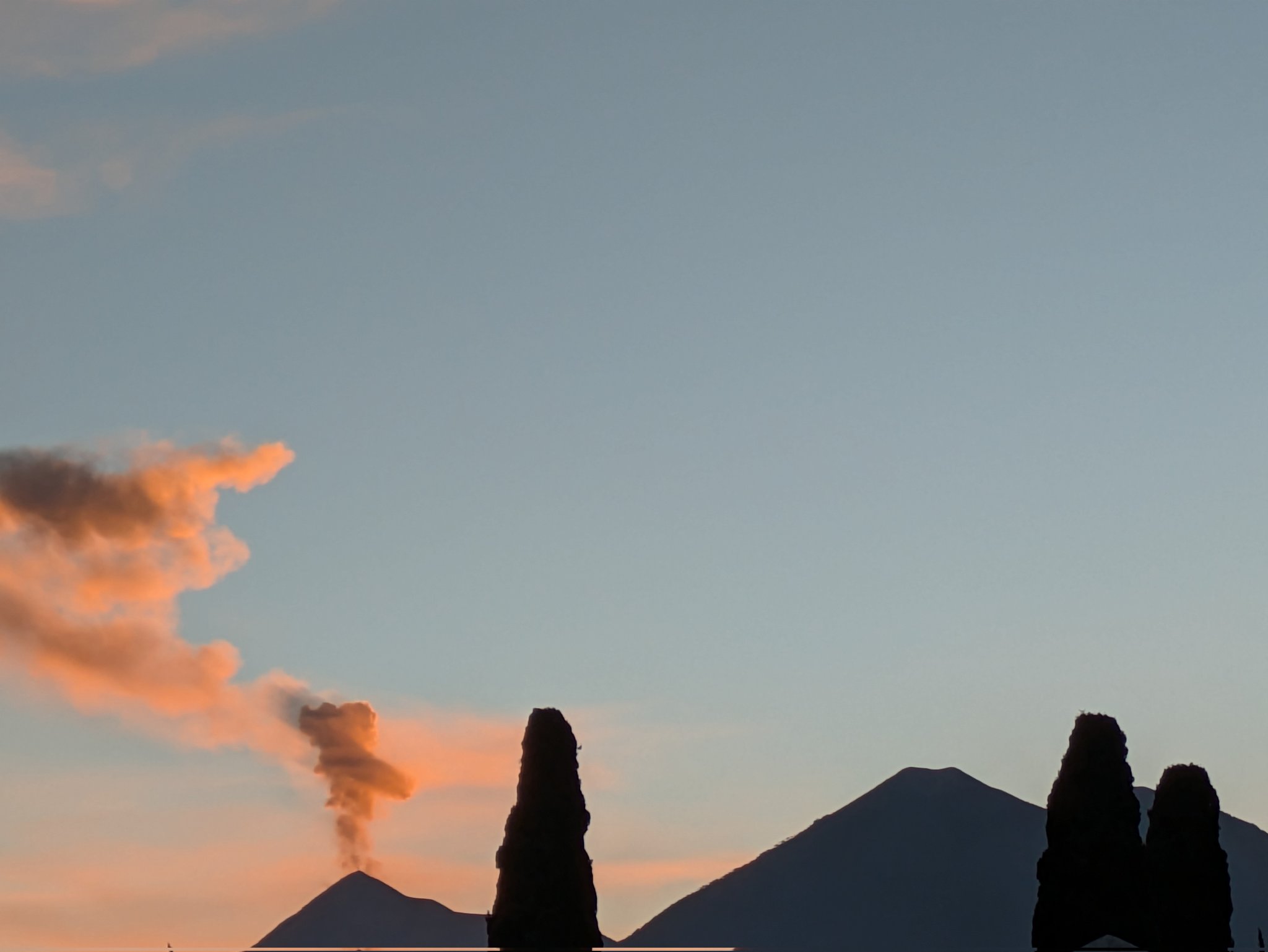 Silhouette of an erupting volcano