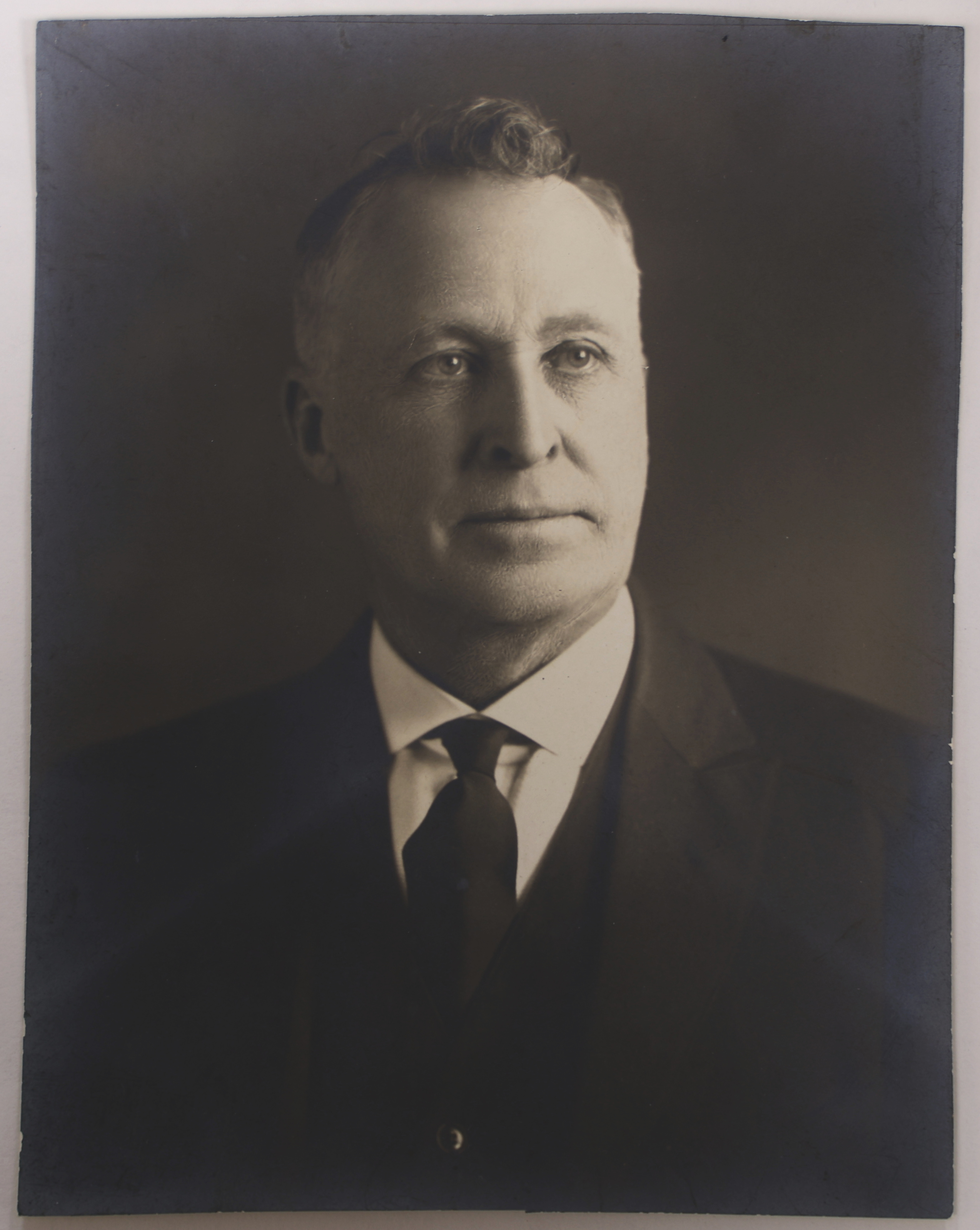 Black and white portrait of a middle-aged William T Fry, a white man with short grey hair, posing in a black suit.
