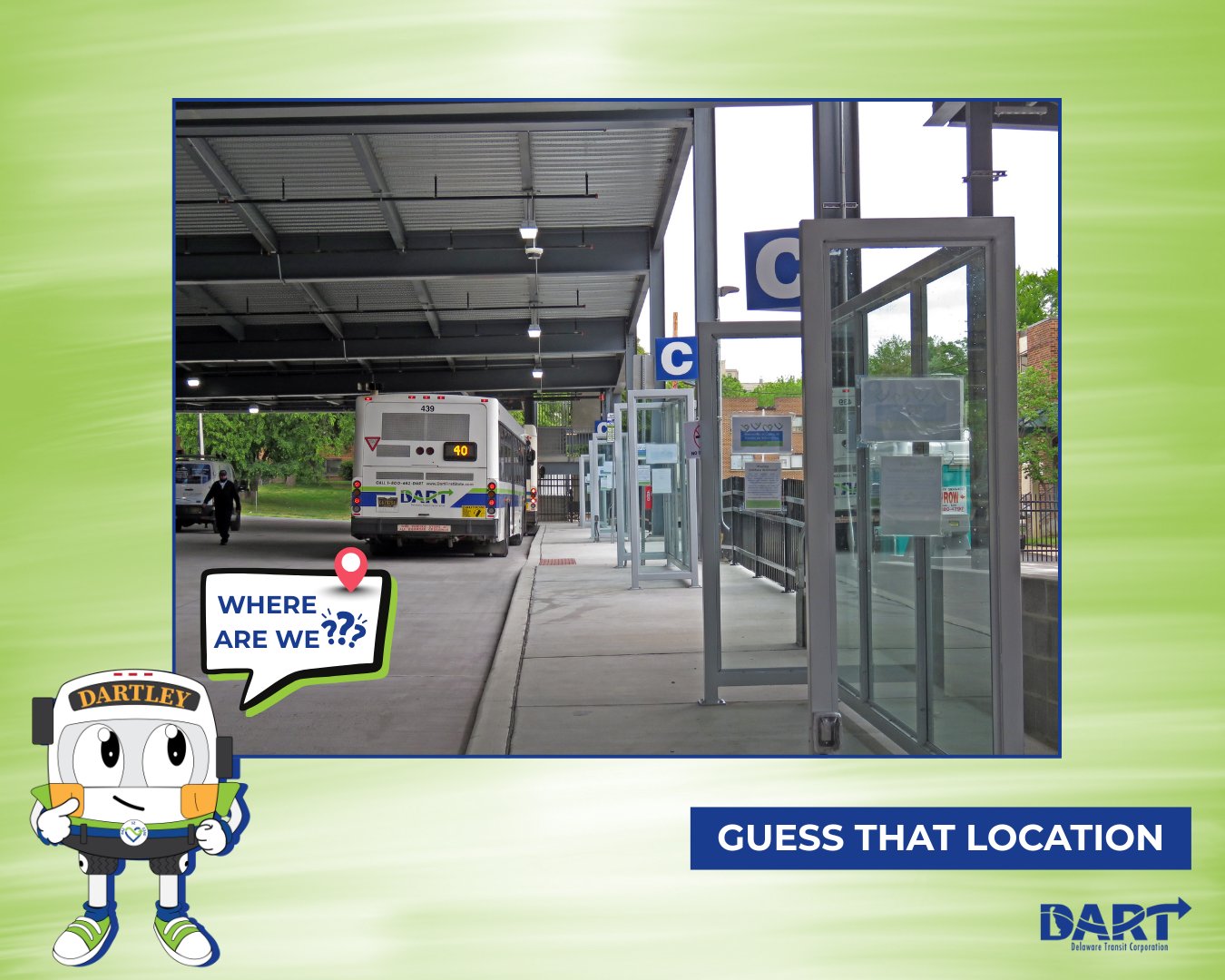 DARTLEY standing Infront of an image of a bus stop with the text saying guess that location