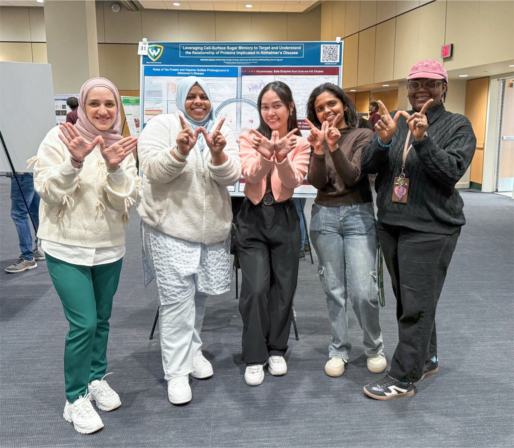 6 graduate students at a research symposium