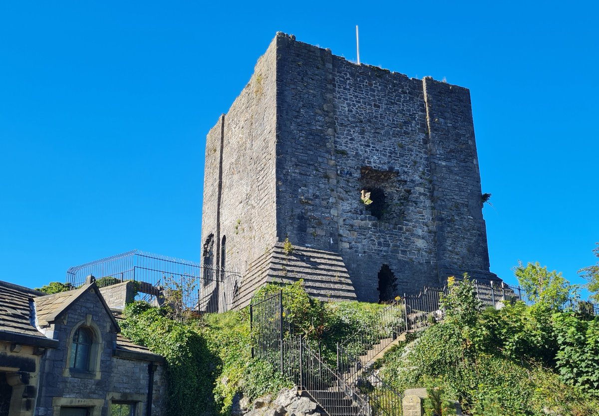 Photograph of Clitheroe Castle keep against a sunny blue sky.